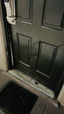 Door was obviously knocked in on the bottom leaving about a 1" gap opening into the room.