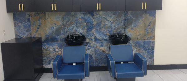 Clean and comfortable shampoo area  with seats that recline.