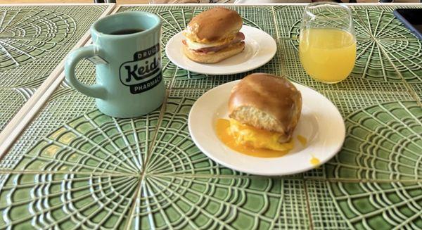 Ham, egg, & cheddar slider and the egg & cheddar slider with a mimosa and an earl grey tea.