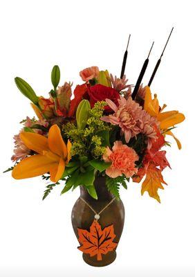 Colored glass vases with keepsake wooden Maple Leaf ornament.