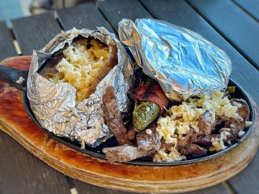 The Asado plate with a baked potato and stuffed jalapeño