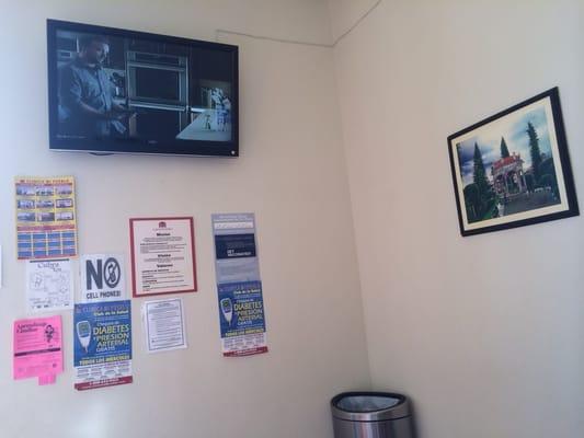 TV and signs on wall.