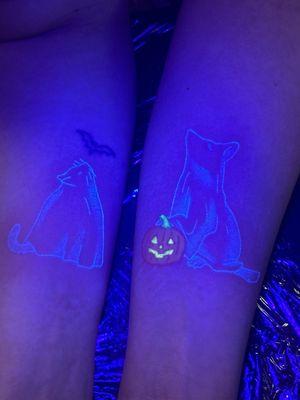 My black light cat and dog tattoos