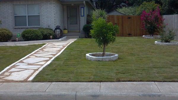 Zoysia grass, limestone block edging and flagstone pathway complete.