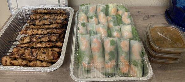 Chicken stick party tray and shrimp spring roll party tray with peanut sauce.