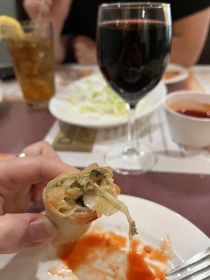 Egg roll and glass of Merlot