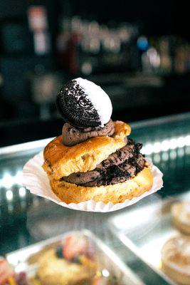 One of our specialty Cream Puffs, filled with chocolate and topped with a chocolate dipped Oreo.