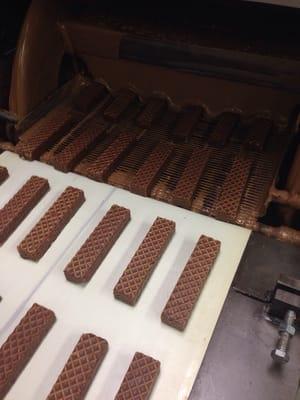 Peanut butter nutty bars headed into the chocolate shower