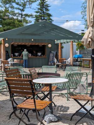 Looking from one of the umbrella covered tables towards where you place and pick up your order.