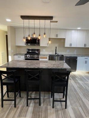 Beautiful kitchen remodel! New floors, cabinets, custom kitchen island and counter tops, light fixtures, and paint.