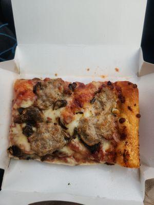 A slice of mushroom, cheese, and sausage pizza. Was delicious!!