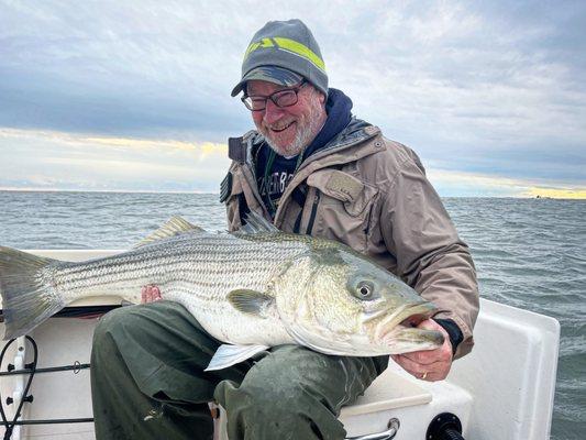 Striped bass call LBI home in the fall. Bob Bruns caught this bass fishing near Barnegat Light with Captain Greg aboard Fish Head Charters.