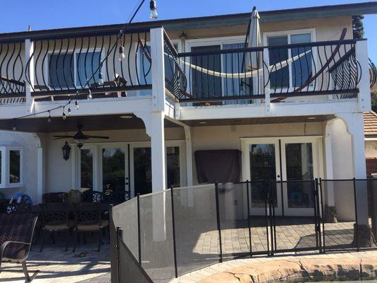 Yorba Linda balcony patio cover, custom fireplace, Bbq, waterfall, and pool.