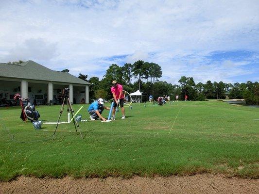 Private video lesson with Trackman clubfittings in background.