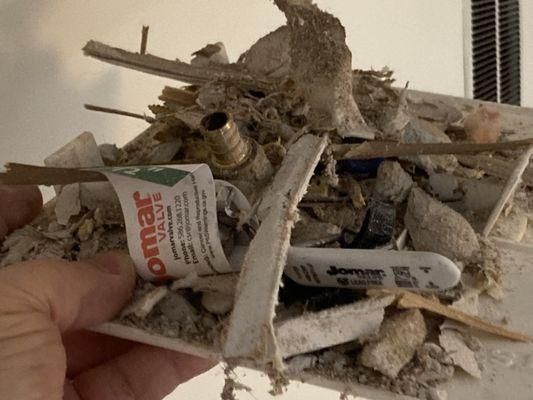 HomeShore contracting debris left on access door. Home owner cleaned the door and debris that had fallen into the dining room below.