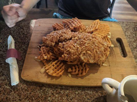 Corn flake breaded chicken cutlet with waffle fries and money mustard.