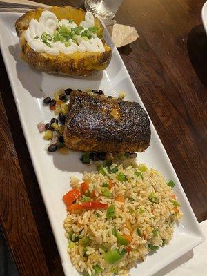 Mahi-Mahi on a black bean, citrus medley bed, steamed rice with cubed bell peppers and scallions, baked potato.