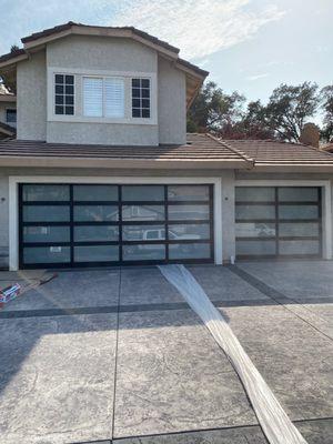 Installed 2 Fullview Aluminum garage door with black frame and white laminate glass.