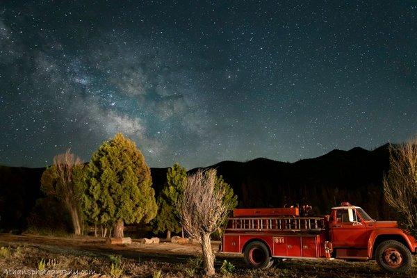 One of our vintage firetrucks on the lake beach at night.