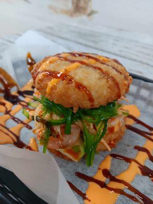 Po-Kay Burger! Spicy kani & shrimp covered with sliced avocado & seaweed, drizzled in house sauce & spicy mayo, sandwiched in rice patties!