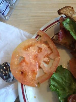 Another shot of the yummy tomato, it came with my five dollar BLT sandwich bread three slices of bacon and this piece of crap