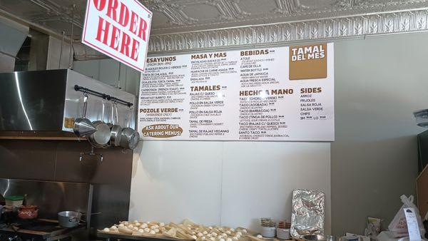 Menu and tamales being made