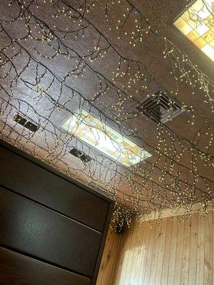 Ceiling deco- old wood with stained glass inserts lined with "star" lights. Picture doesn't really do it justice.