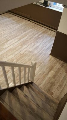 Ceramic plank tile installation on Basement stairs and walls