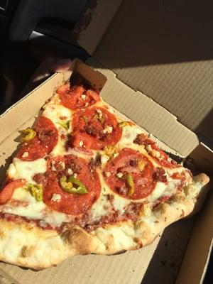 This single slice took up most of the small pizza box. Thin but not too thin. Yummy cornmeal crust - the rough little balls on the bottom.