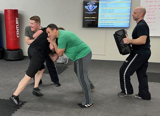 Krav Maga self-defense VIP drill to protect your loved ones at Triumph Martial Arts in Clive!