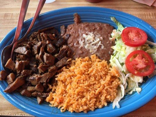 Plate of lengua, rice, beans and a side of corn tortillas