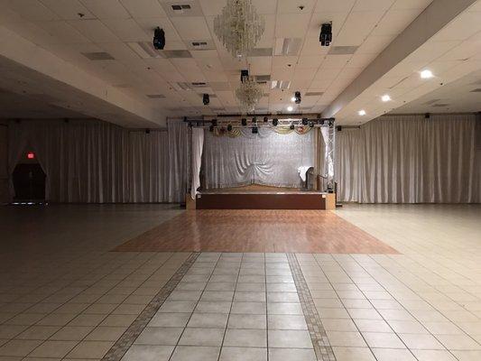 Stage, dance floor, and chandeliers.