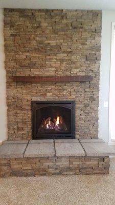 Kozy Heat Bayport 36 Gas Fireplace with Custom Ledgestone Panel and Masonry Hearth and Rustic Beam Shelf Mantel