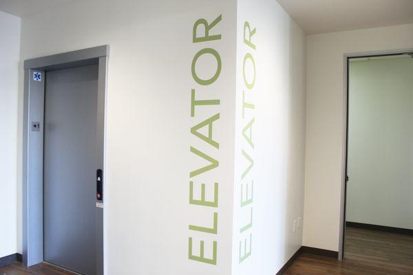 There is an elevator located on the ground floor near the front entrance.