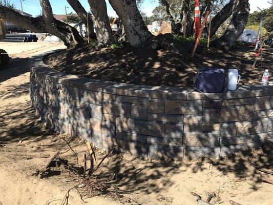 Block retaining wall.  cal stone tan charcoal is the color