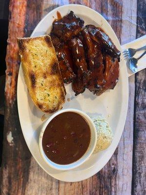 Todays special; ribs and chicken with 2 sides baked beans and potato salad and it comes with garlic bread