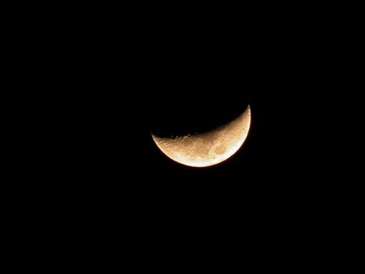 The moon, like a Dragon's eye, hanging low over the East in early evening, 2 days before first quarter. I've always called it a Dragon Moon.