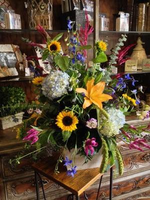 Mixed flowers designed in a garden box.  Excellent choice for making a statement or memorial tribute