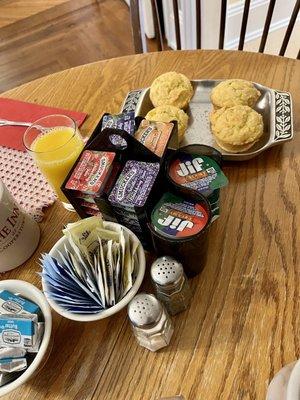 Jams, peanut butter, butter pats, condiments and amazing corn muffins at the breakfast table