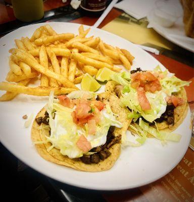 Two steak tacos and fries