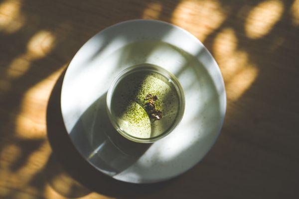 Matcha Panna Cotta topped with matcha powder and gold flakes