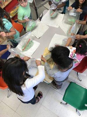 The children are shaking the bags as fast as they could ice & milk to make the ice cream.