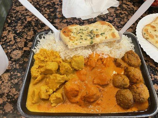 Three entree meal: tiki masala, butter chicken, basmati rice and garlic butter naan.