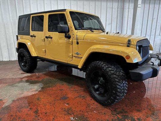 Car sitting in puddle in garage on Tiki Motors