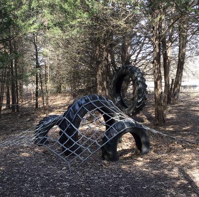 Recycled tractor tires create a climbing feature.