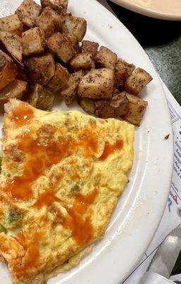 Western omelette and home fries. W/hot sauce on the omelette.   I had eaten half of the plate before I took the picture.