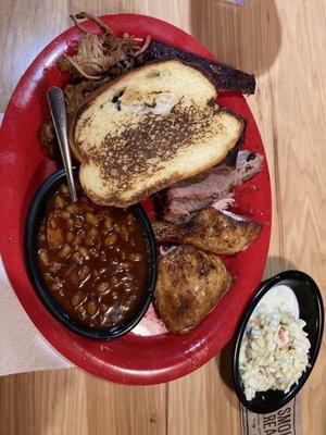 Sonny's Sampler.  Savory fall off the fork pork BBQ ribs pulled pork and chicken.  Baked beans and coleslaw and garlic bread