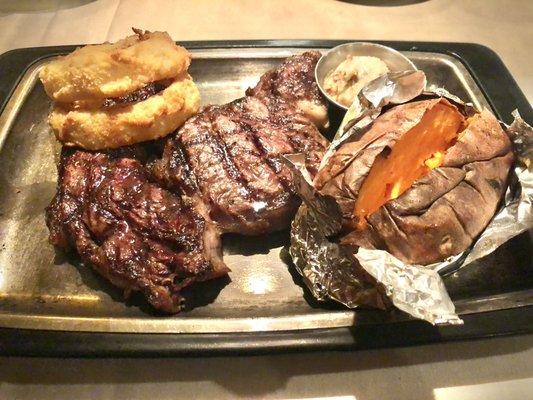 Prime Rib, sweet potato, house-made cinnamon butter on the side, with two steakhouse onion rings.