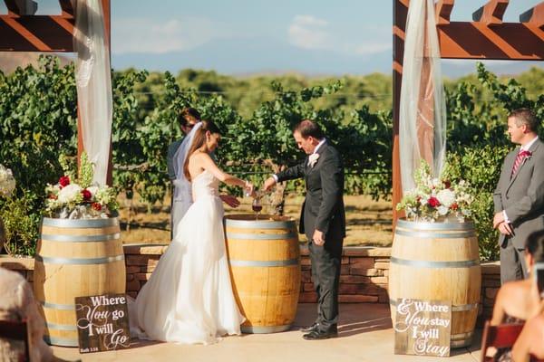 Floral arrangements on top of barrels for our winery wedding.