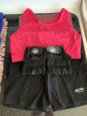 One Black Bike Shorts, one pair of black leather gloves, and one Hot Pink Sports Bra.